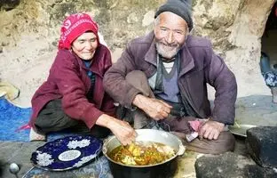 (ویدئو) پخت تماشایی دمپخت محلی توسط زوج مسن غارنشین افغانستانی